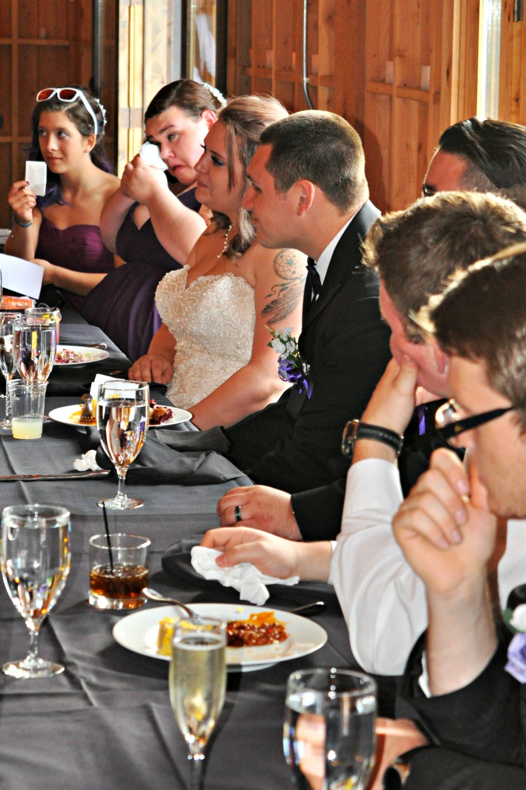 Head table during emotional wedding toasts